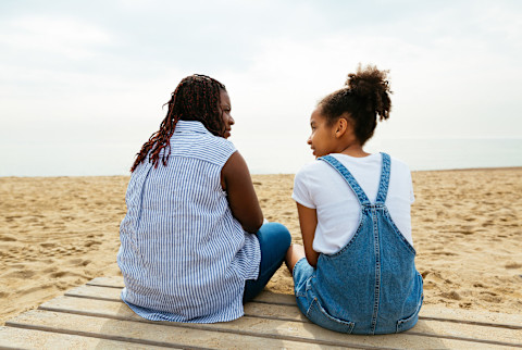 Mother and Daughter Talking on the Beach Mother and Daughter Talking on the Beach