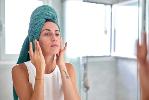 Woman putting on serum Woman putting on serum