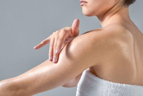 woman applying body oil
