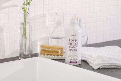 mindbodygreen's postbiotic hand wash by a sink mindbodygreen's postbiotic hand wash by a sink