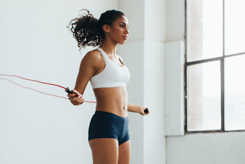 Fit Woman Jumping Rope In A Gym. Fit Woman Jumping Rope In A Gym.