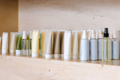 Bottles of beauty products and skin care products on a shelf