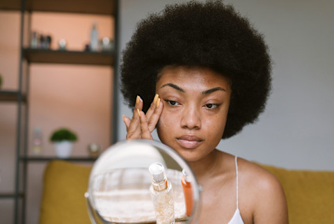 woman putting on skincare