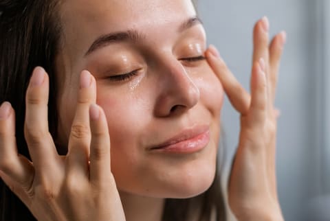 woman touching under eye cirlces