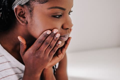 woman with beautiful skin applying a moisturizer 