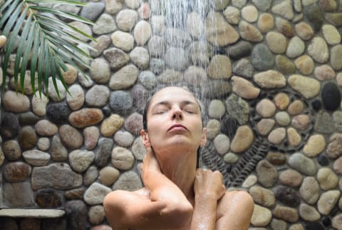 woman taking shower outdoors