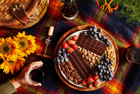 holiday spread with plate of chocolate, fruits, and nuts