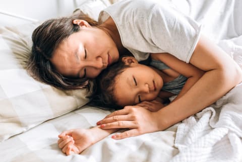 Young Mother And Her Daughter Sleeping