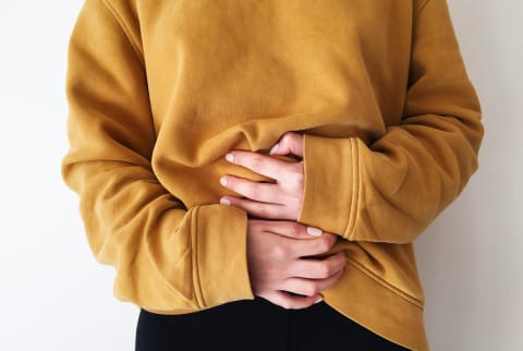 woman holding gut