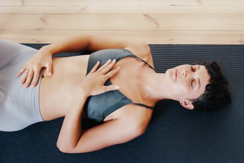 Woman Lying on the Floor Doing Diaphragm Exercise