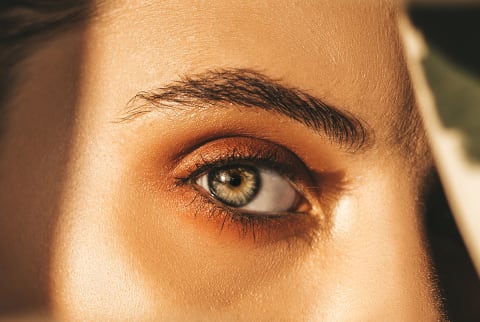 Woman with green eyes and full brows