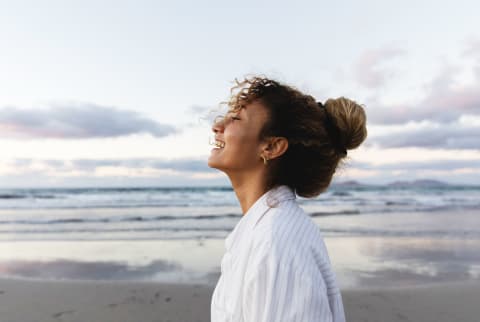 Happy Woman Laughing on the beach