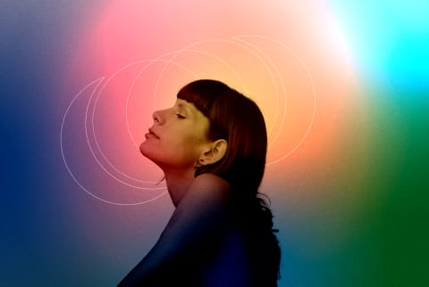 profile of a woman in front of colorful, mystical background