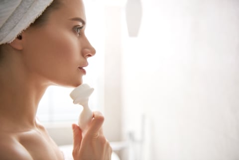 Woman with a facial brush