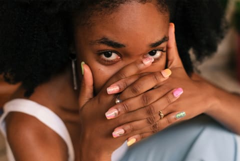 woman with hands over her face