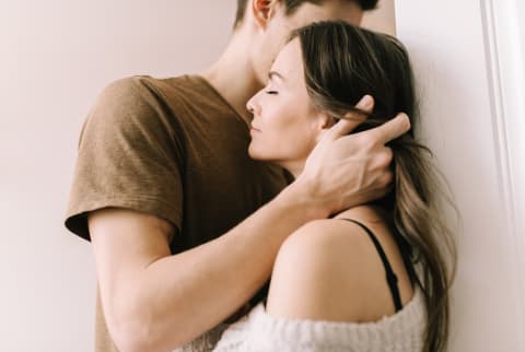 Couple Embracing in a Bedroom