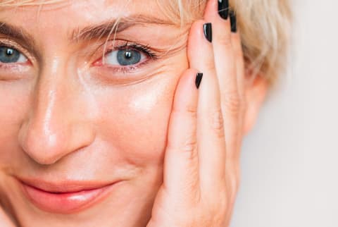 woman holding her face woman holding her face