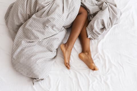 woman's feet in bed