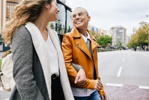 Couple Walking Arm in Arm Together In the City