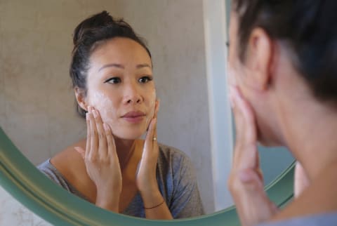 Indonesian Woman Washing Her Face Using Beauty Cleanser Soap stock photo