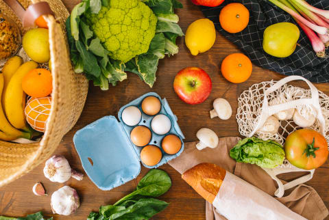 Fresh Fruits And Vegetables In Reusable Bags On Kitchen Table