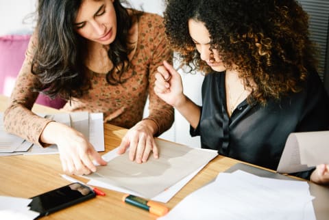 Woman Tutoring Another Woman in School