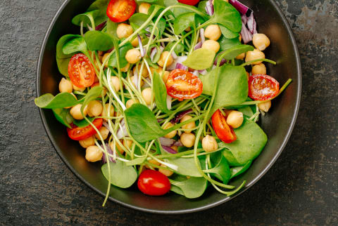 Vegan salad with purslane, chickpeas, tomatoes, and red onion
