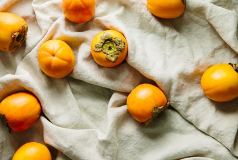 Persimmon Fruit On Linen