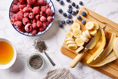 Overhead Image of Raspberries, Blueberries, Bananas, Chia Seeds, and Honey