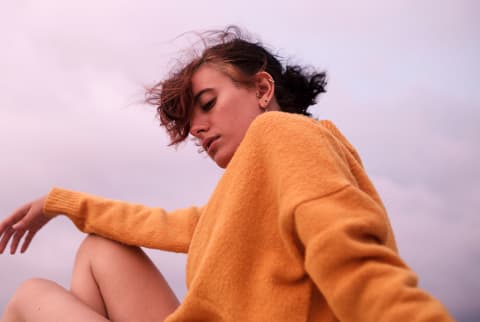 anxious woman with orange sweater