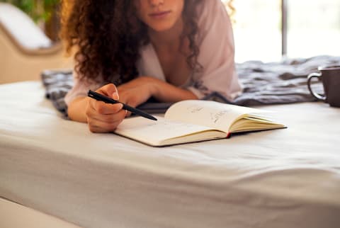 Image of a person enjoying alone time by journaling.