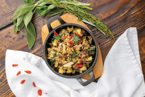 wild rice stuffing with apples and herbs in a cast iron pot