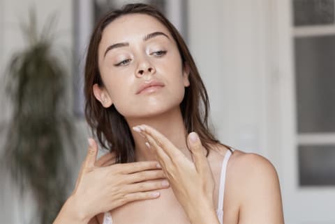 Woman With Glowing Skin doing lymphatic drainage massage