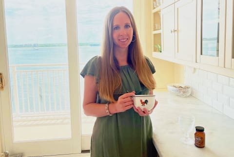 woman with mug in front of window