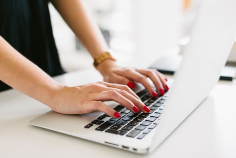 woman's hands typing on laptop woman's hands typing on laptop
