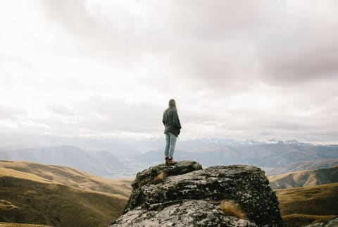 Young Woman Hiking Alone In a Vast Landscape