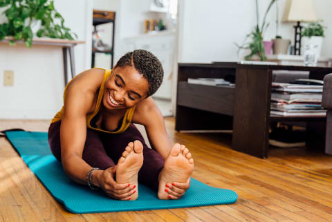 woman smiling while stretching