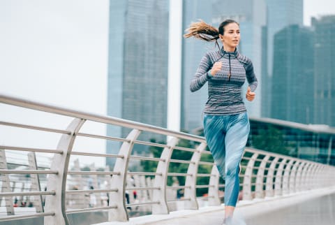 Woman Running Outdoors In Cool Weather