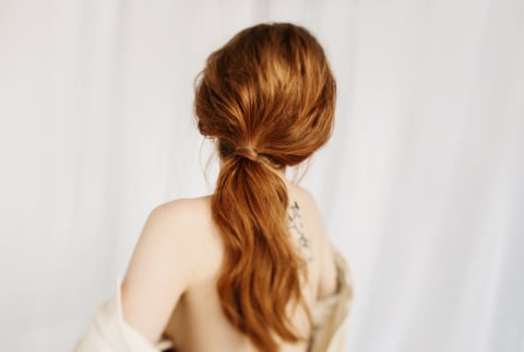 Red Headed Woman With a Styled Wavy Ponytail