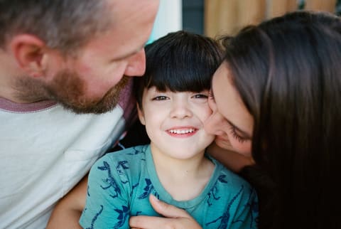 Parents And Child Laughing