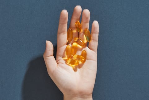 Hand holding vitamins