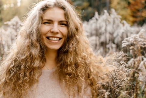 Portrait Of Beautiful Young Woman With Blonde Curly Hair