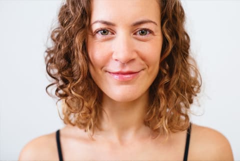 woman with under eye bags smiling at camera