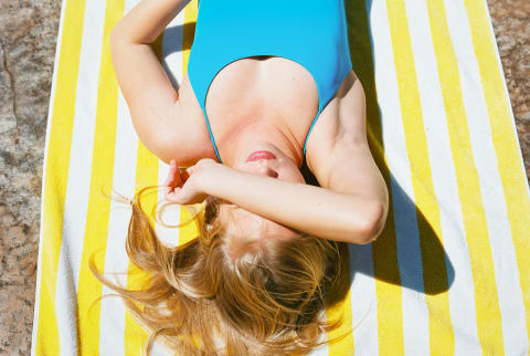 Woman In Blue Bathing Suit On Sunny Day With Sunglasses