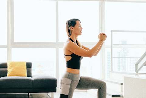 Woman Doing Lunges in Her Living Room Woman Doing Lunges in Her Living Room