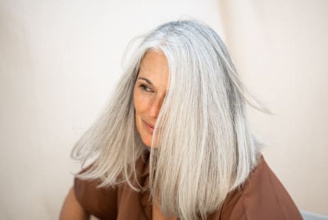 Older woman waving her hair Older woman waving her hair
