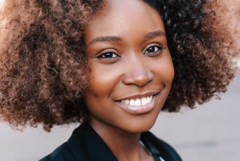 Close Up Portrait Of a Woman With Natural Hair and a Beautiful Smile