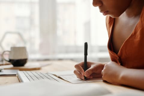 Young black woman journalling at her desk