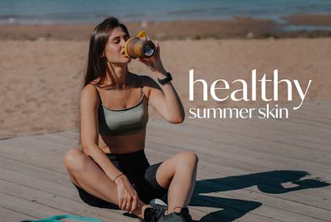 Healthy Summer Skin: Woman drinking water on the beach after working out Healthy Summer Skin: Woman drinking water on the beach after working out