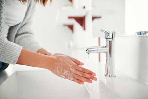 Woman washing hands at the sink